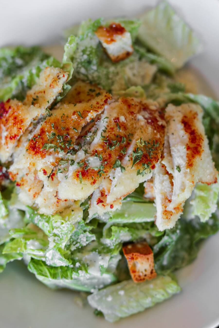 Chicken Caesar salad with breaded chicken, shaved parmesan and croutons