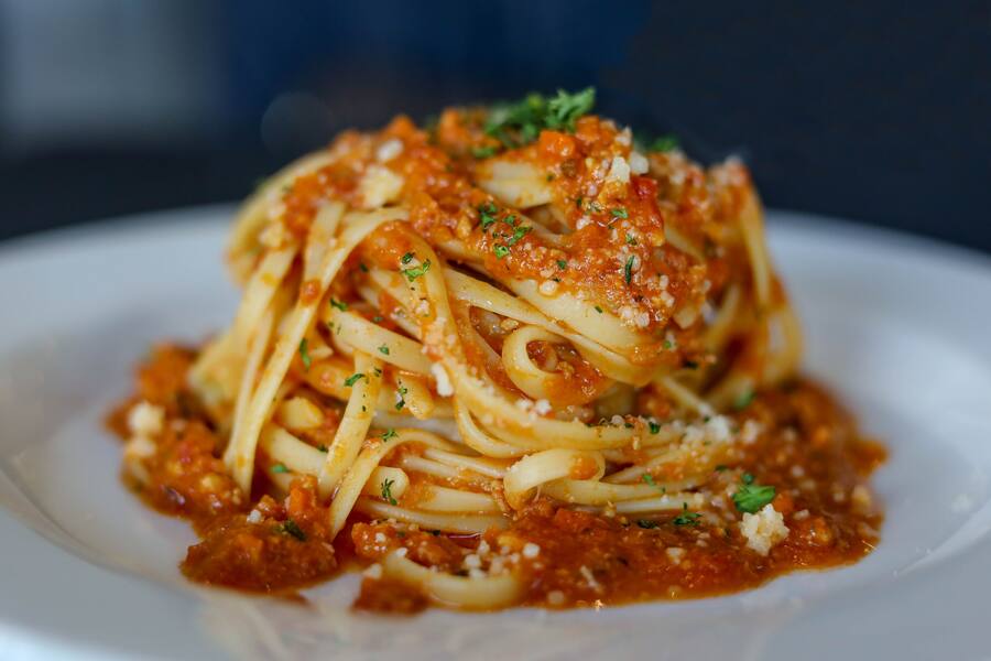 Linguine tossed in slow-simmered chicken ragù with grated pecorino Romano