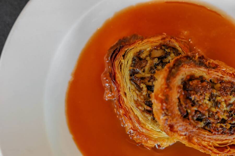 Crisp phyllo strudel filled with duck confit and wild rice in cranberry wine sauce
